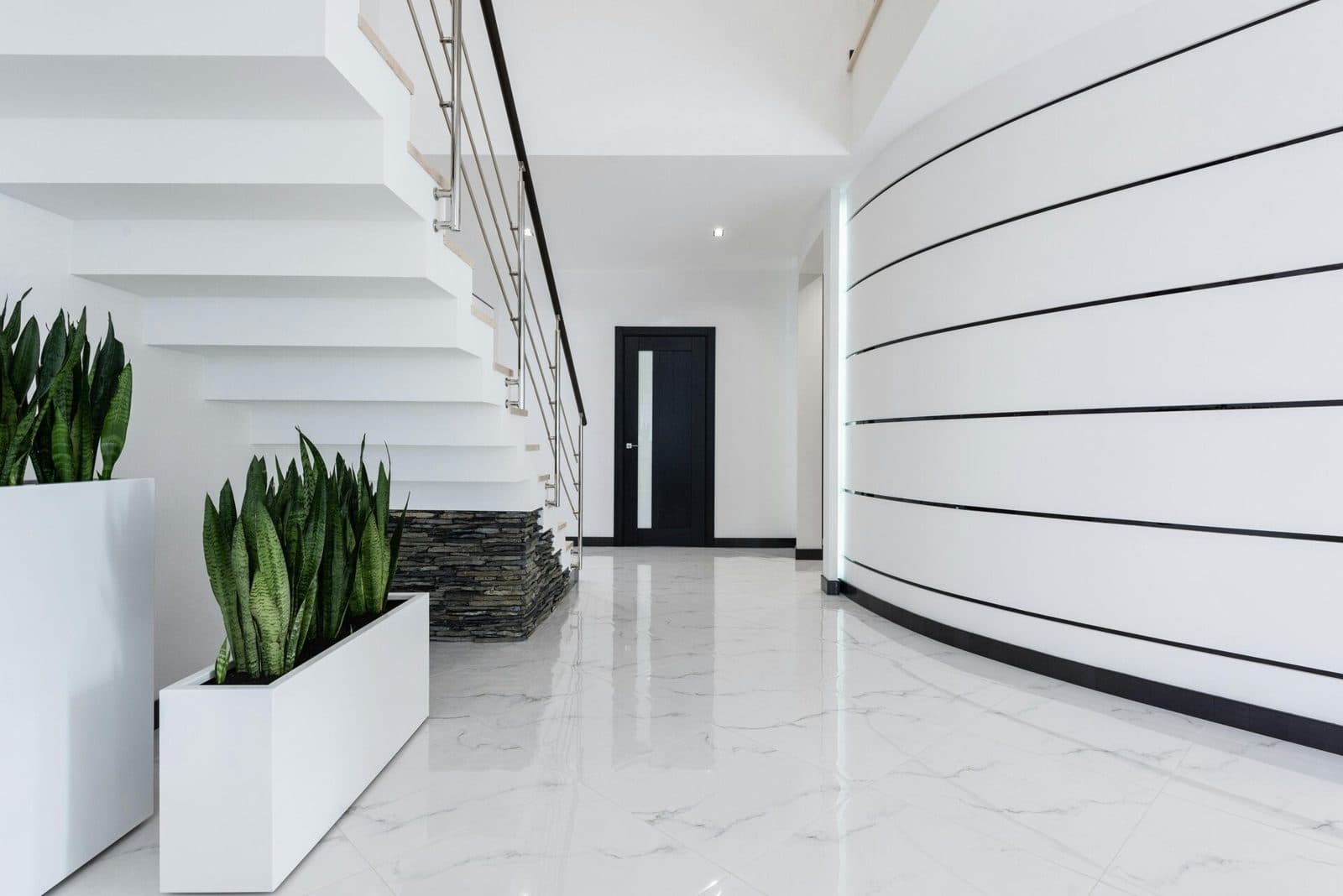 Illustrative photo: a bright white commercial lobby with a staircase