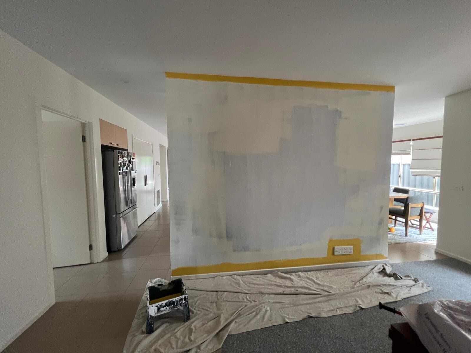 Feature wall taped and undercoated with drop sheets down