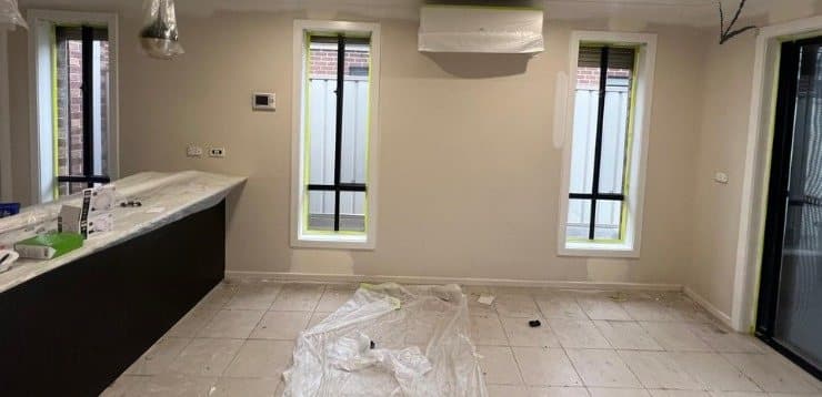 Kitchen and dining area masked and drop sheeted before painting