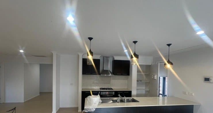 Open plan kitchen after painting with clean white walls and ceiling