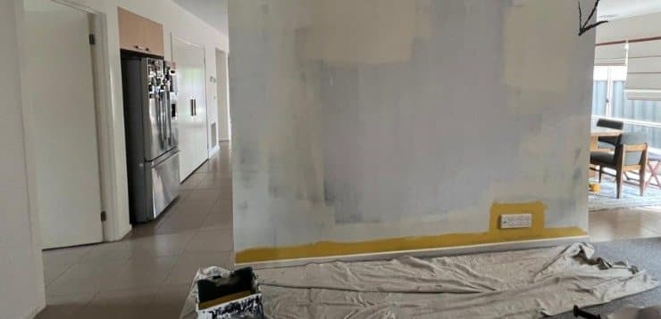 Freestanding wall part way through undercoat, taped and drop sheeted