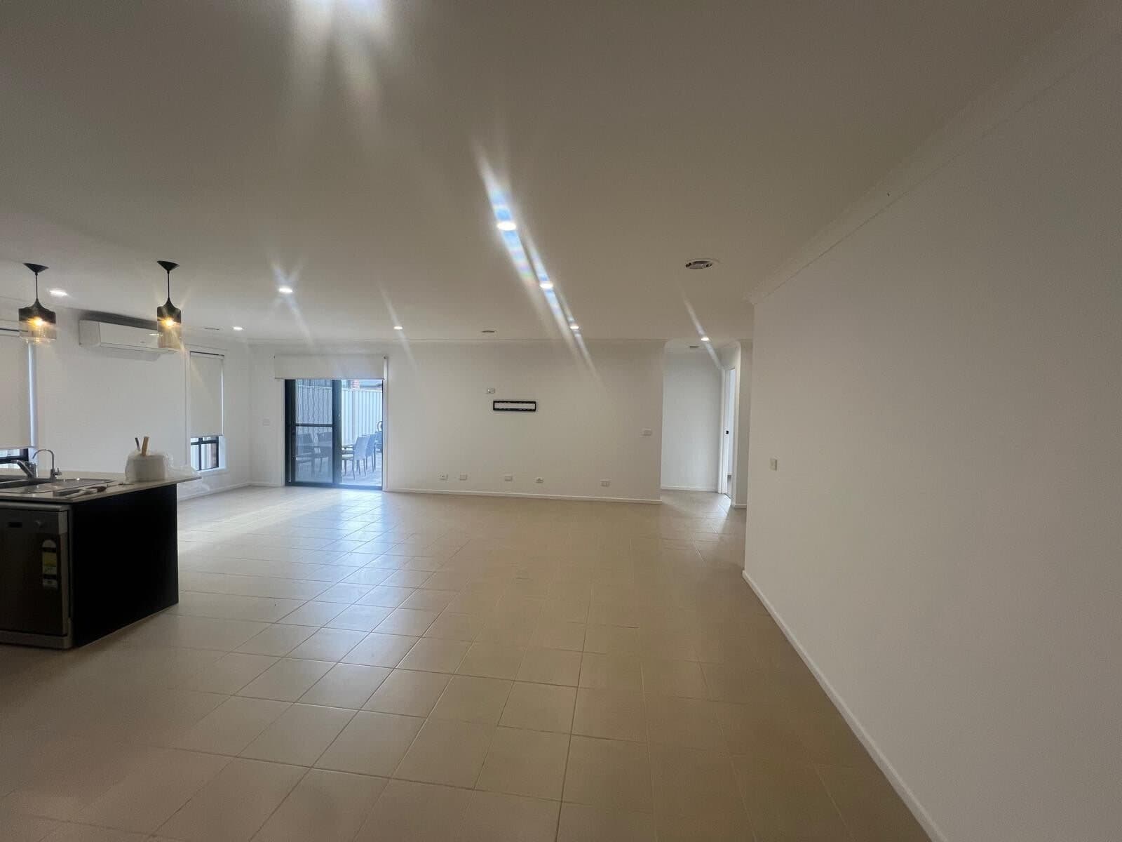 Large open plan living room with freshly painted walls and ceiling