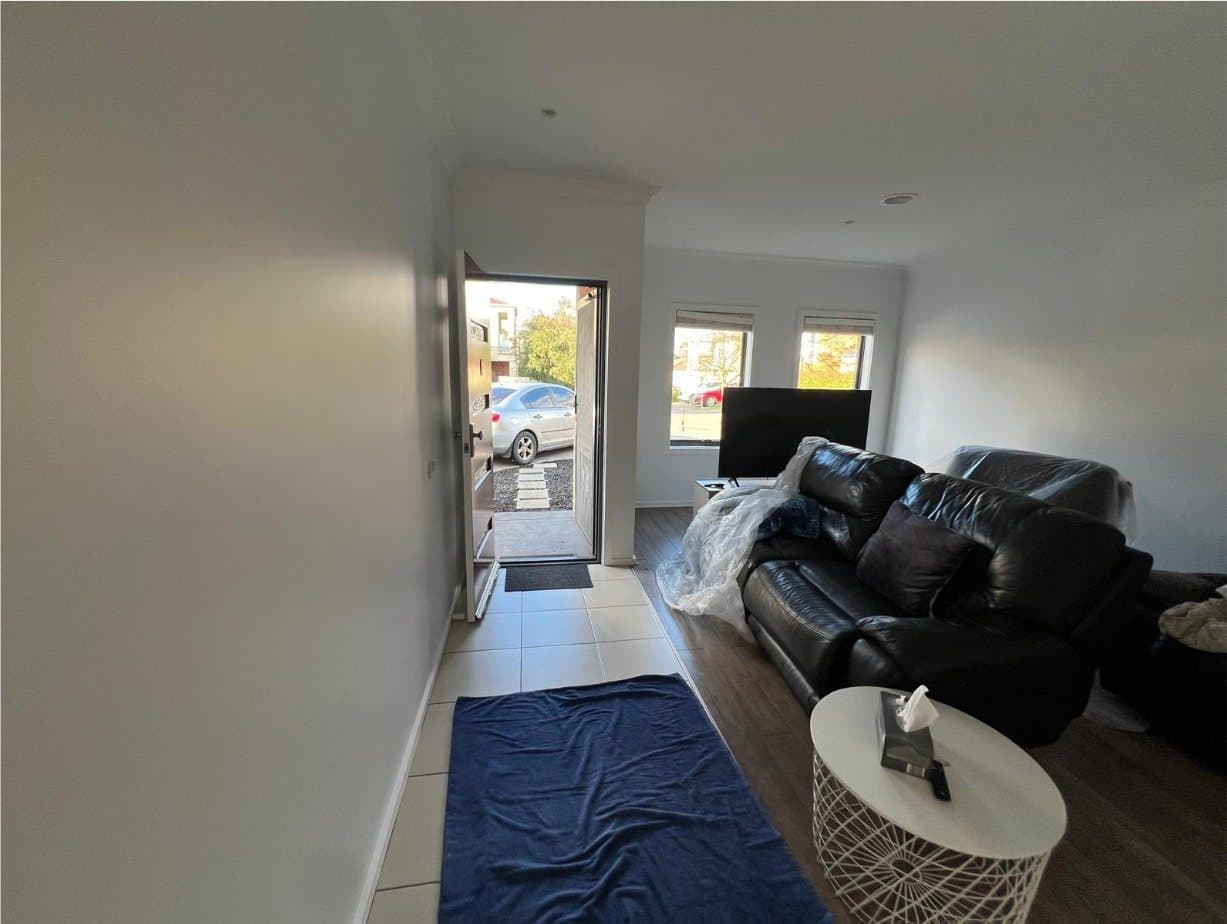 Living room after repainting, furniture protected and floors covered