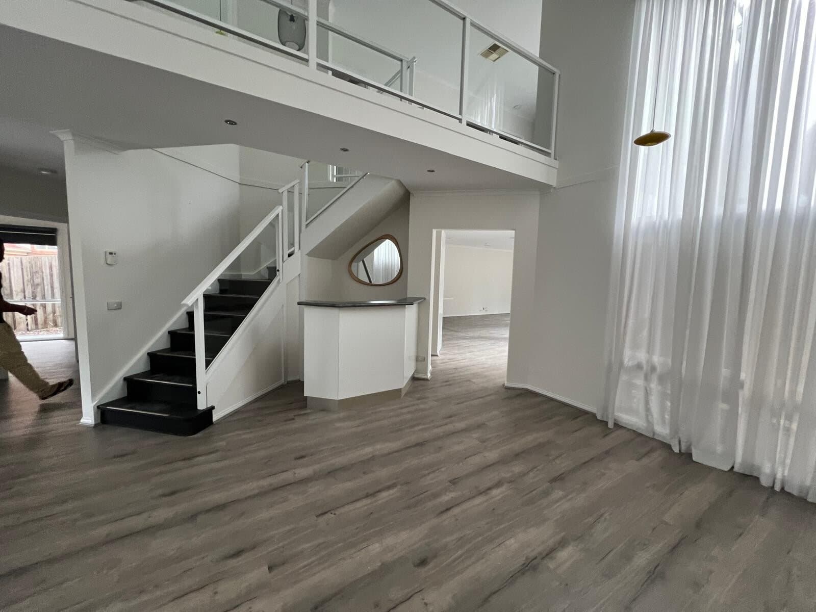Double height void and staircase freshly painted white