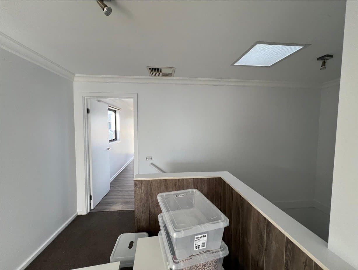 The same landing repainted in a clean white with fresh ceiling and cornice